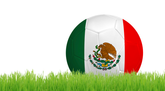Soccer ball on green grass with colors of Mexican flag isolated on white background