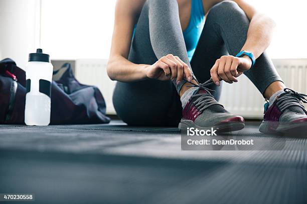 Wormseye View Of Gym Floor And Woman Tying Shoelaces Stock Photo - Download Image Now