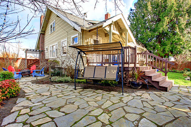 istock Stoned backyard with covered patio swing and barbecue area 470230833