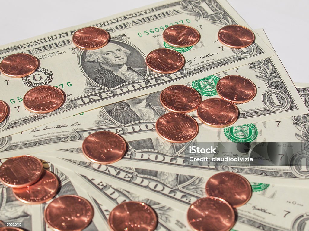 Dollar coins and notes One cent coins and One Dollar banknotes  currency of the United States useful as a background 2015 Stock Photo