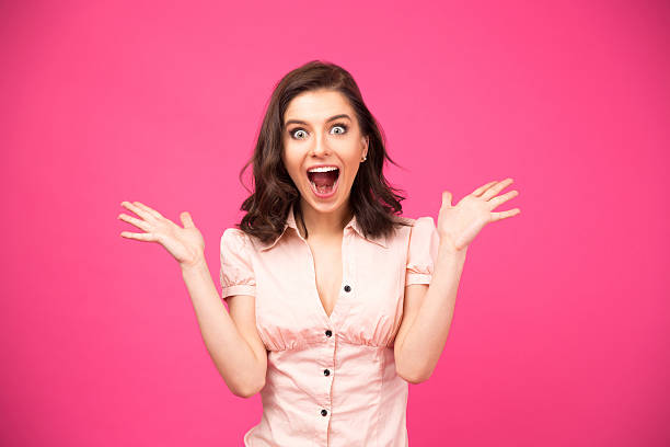 istock Surprised woman shouting over pink background 470232400
