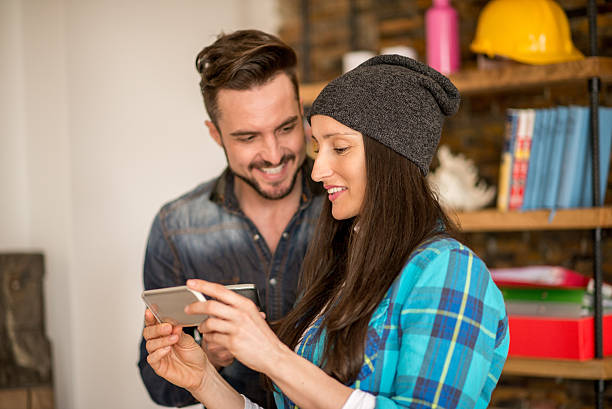 istock Couple in the office with mobile phone 470233544