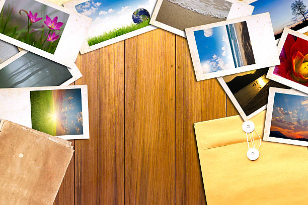 istock Old paper and photos on wooden table 470236399