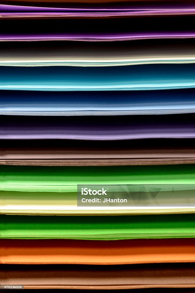 Sheets of Coloured Paper A horizontal store display of sheets of coloured paper showing a spectrum of rainbow colours. 2015 Stock Photo