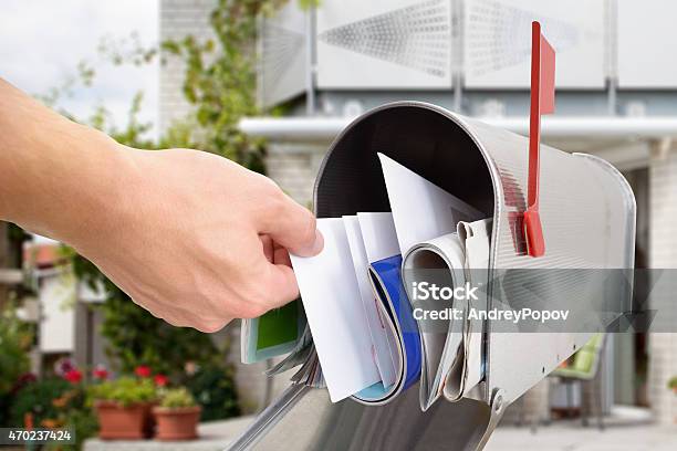 Man Taking Letter From Mailbox Stockfoto en meer beelden van Brievenbus - Gefabriceerd object - Brievenbus - Gefabriceerd object, Post, Postbode