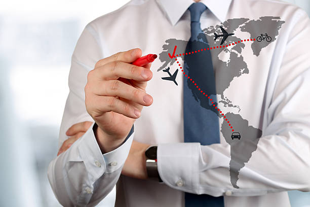 istock Young business man drawing an airplane routes on world map. 470244384
