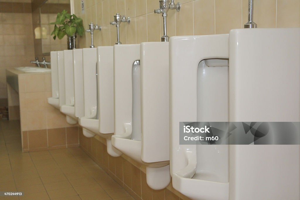 Line of white urinals in public toilets Bathroom Stock Photo