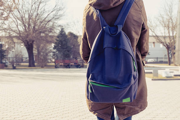 istock Rear view of hipster girl carring backpack on her back 470247596