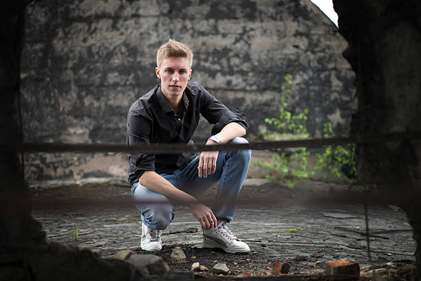 istock Young attractive man on abandoned background. Sitting 470247604