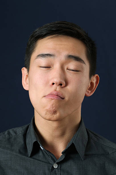 istock Young Asian man with closed eyes 470249384