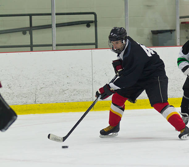 istock Hockey player skates and stickhandles the puck during a game 470250621