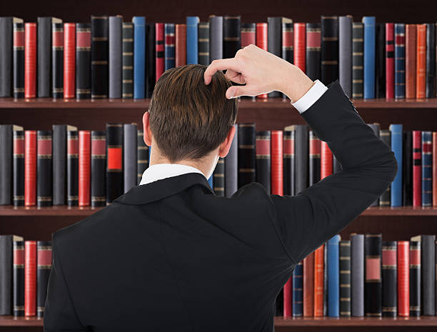 istock Young Man In A Suit Scratching His Head 470252496