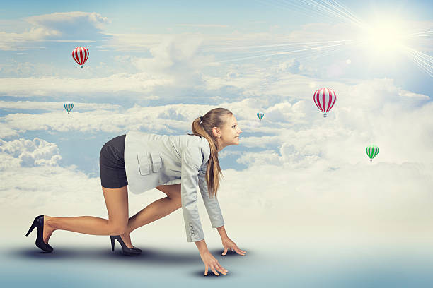 istock Woman standing in running start pose. Sky with clouds and 470259074