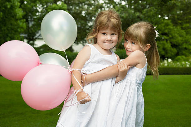 istock Playful Little Bridesmaids Holding Balloons 470259377