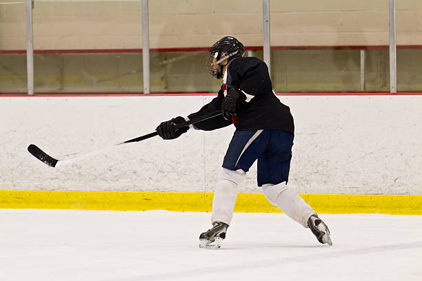 istock Ice hockey player takes a slap shot 470269991