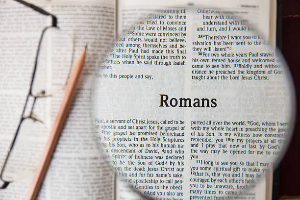 CHIANGMAI, THAILAND, March 3,2015. Reading The New International Version of the Holy Bible on the page of " romans " at home. March 3,2015