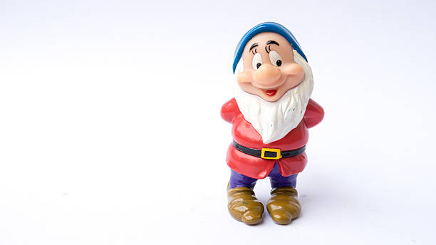 Figure toy of dwarf from Disney's fantasy film Snow White Kuala Lumpur, Malaysia - March 19, 2015 : Figure toy of dwarf from Disney's 1937 American animated musical fantasy film Snow White and the Seven Dwarfs. Film was produced by Walt Disney Productions animator photos stock pictures, royalty-free photos & images