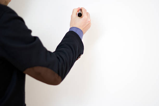 istock Business man writing at a whiteboard 470285661