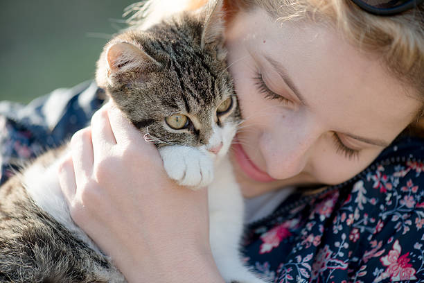 istock Blonde woman playing with her adorable cat 470288636