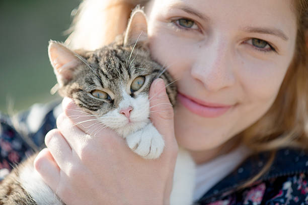 istock Blonde woman playing with her adorable cat 470288714