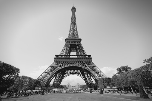 Paris, France - Eiffel Tower seen from Champ de Mars. UNESCO World Heritage Site. Black and white toned photo.