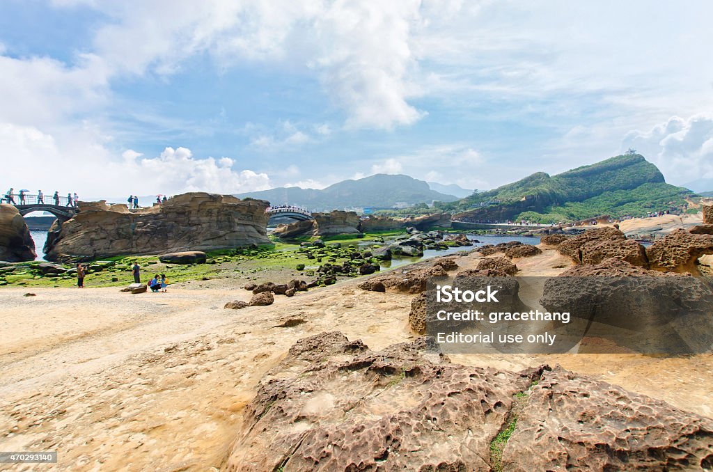 Honeycomb weathering and honeycomb rocks in Yehliu Geopark, Taiwan New Taipei,Taiwan - March 15, 2015: Honeycomb weathering and honeycomb rocks in Yehliu Geopark, Taiwan.People can seen exploring around it. 2015 Stock Photo