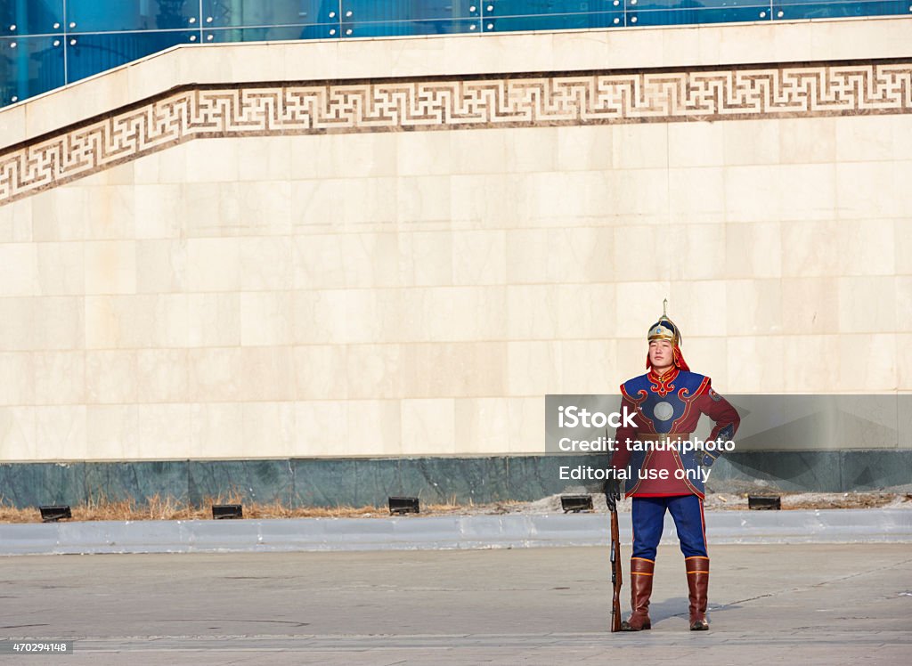 Mongolian Armed Forces Honorary Guard Ulan Bator, Mongolia - January 25, 2015: a Mongolian Armed Forces Honorary Guard, wearing the traditional cavalry uniform, standing outside the Monument of Chinggis Khaanduring in Sukhbaatar Square. 2015 Stock Photo