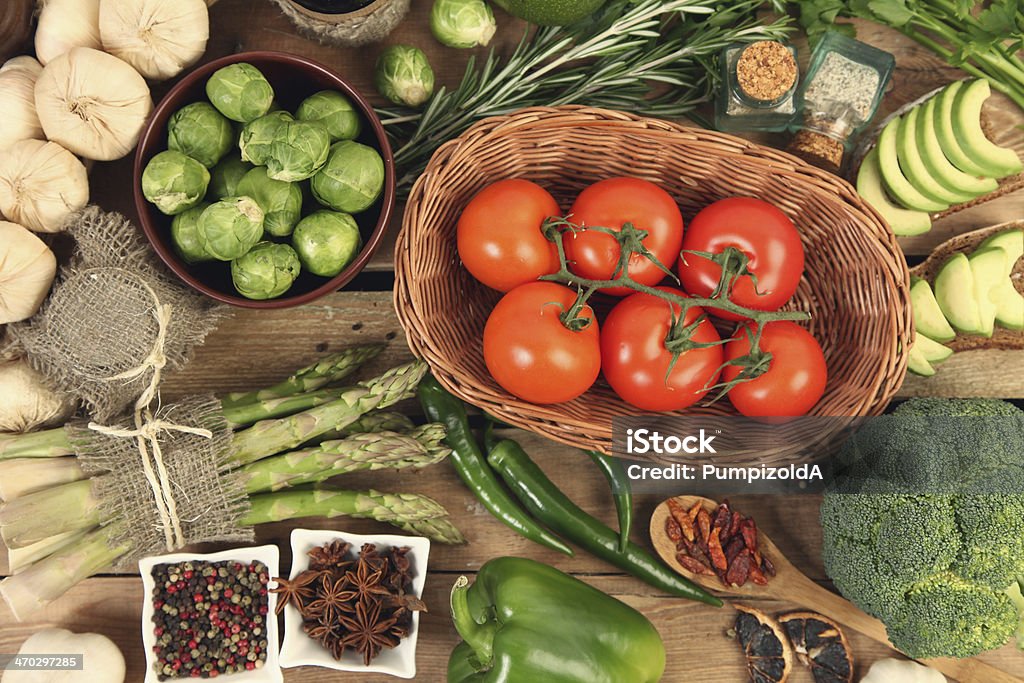 tomatoes in basket fresh vegetables on wooden table Anise Stock Photo