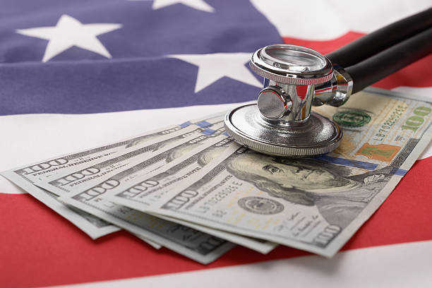 istock Stethoscope On Us Currency And American Flag 470300048