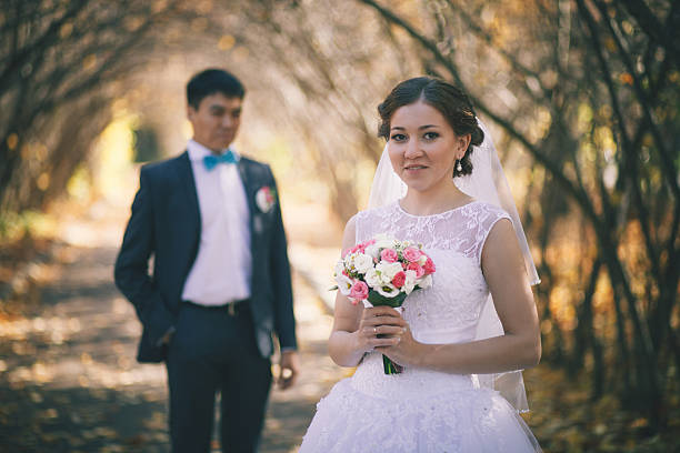 istock Happy newlyweds in park. 470300386