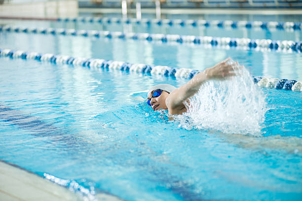istock Young girl in goggles swimming front crawl stroke style 470301470