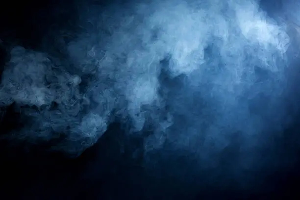 Hazy blue smoke on a black background. Great used as a dramatic overlay texture or background.