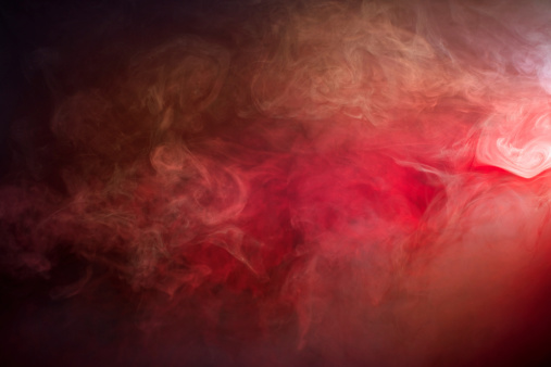 Swirling white, red/orange toned fog/smoke texture photographed in the studio on a black background. Great for use as a textured overlay or background. Has the energy of fire and works well for Halloween.