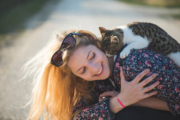 istock Blonde woman playing with her adorable cat 470303800