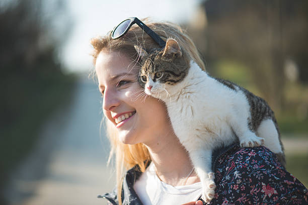 istock Blonde woman playing with her adorable cat 470303806