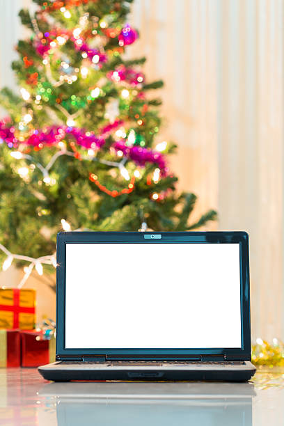 istock laptop with gift box and christmas lights background 470304264