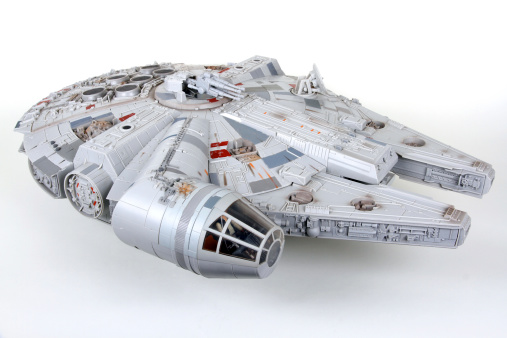 Vancouver, Canada - January 27, 2014: A toy Millenium Falcon, from the Star Wars movie franchise, on a white background. The toy is made by Hasbro