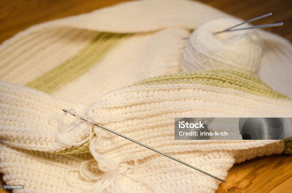 Crocheted scarf Crocheted scarf, crochet hooks and skein on the table. 2015 Stock Photo