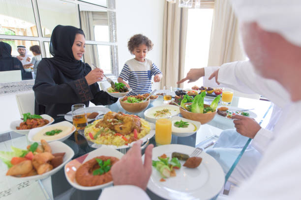 Three generation Arabic family enjoying lunch stock photo