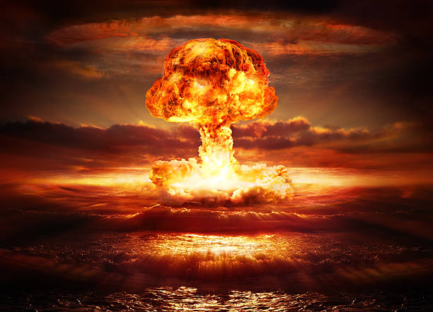 explosion nuclear bomb in ocean testing of atomic bomb over ocean with mushroom clouds - red destroy radioactive contamination stock pictures, royalty-free photos & images