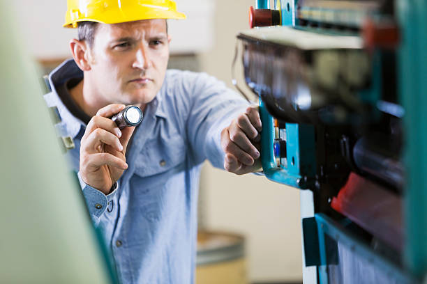istock Man working in printing plant inspecting machine 470310186