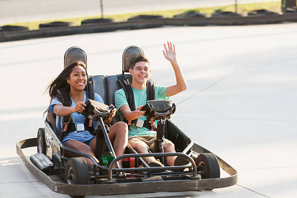 istock Teenage couple riding go carts 470310478