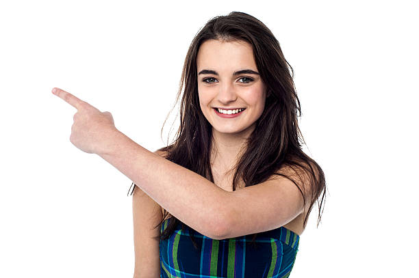 istock Young girl pointing towards copy space area 470311440