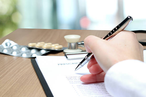 istock Doctor  in a white labcoat writing out RX prescription 470311530