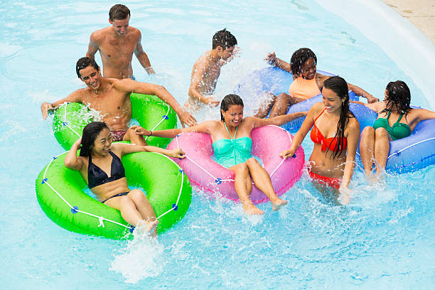 istock Teenage friends floating on innertubes 470314364