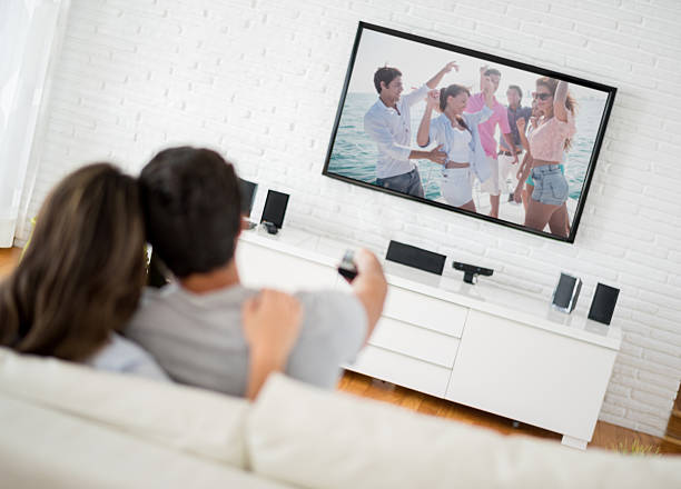 istock Couple watching tv at home 470314398