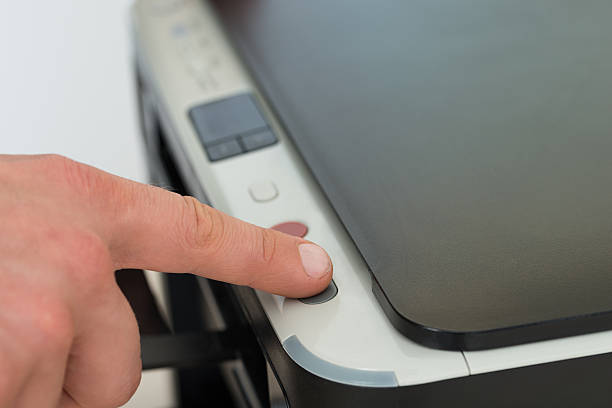 istock Businessman's Finger Pressing Button Of Photocopy Machine 470315178