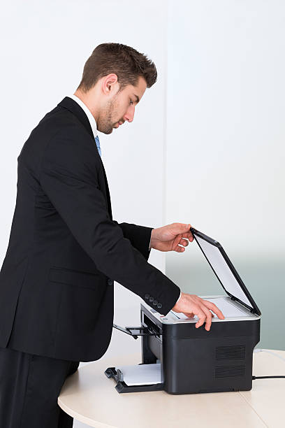 istock Businessman Using Photocopy Machine In Office 470315182