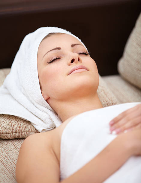 istock beautiful woman lying on a massage table with white towels 470316821