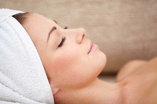 istock beautiful woman lying on a massage table with white towels 470316865